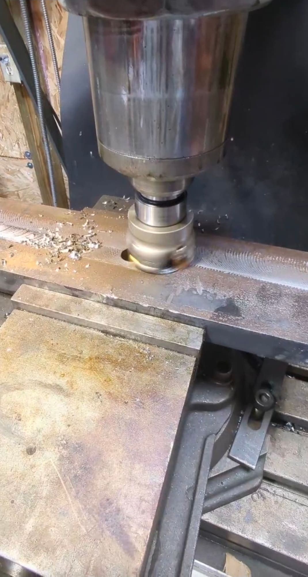 Milling machine cutting a slot in steel stock for a custom part