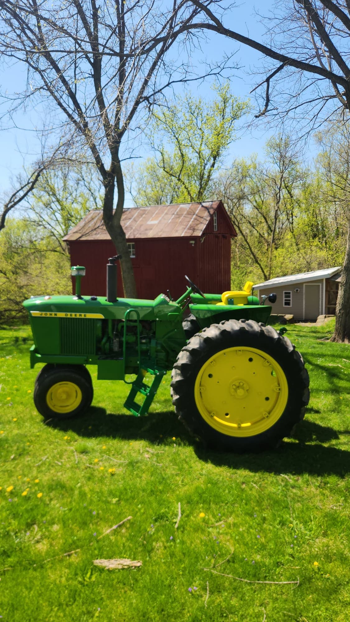 Dan's restored John Deere 3010 in front of the barn