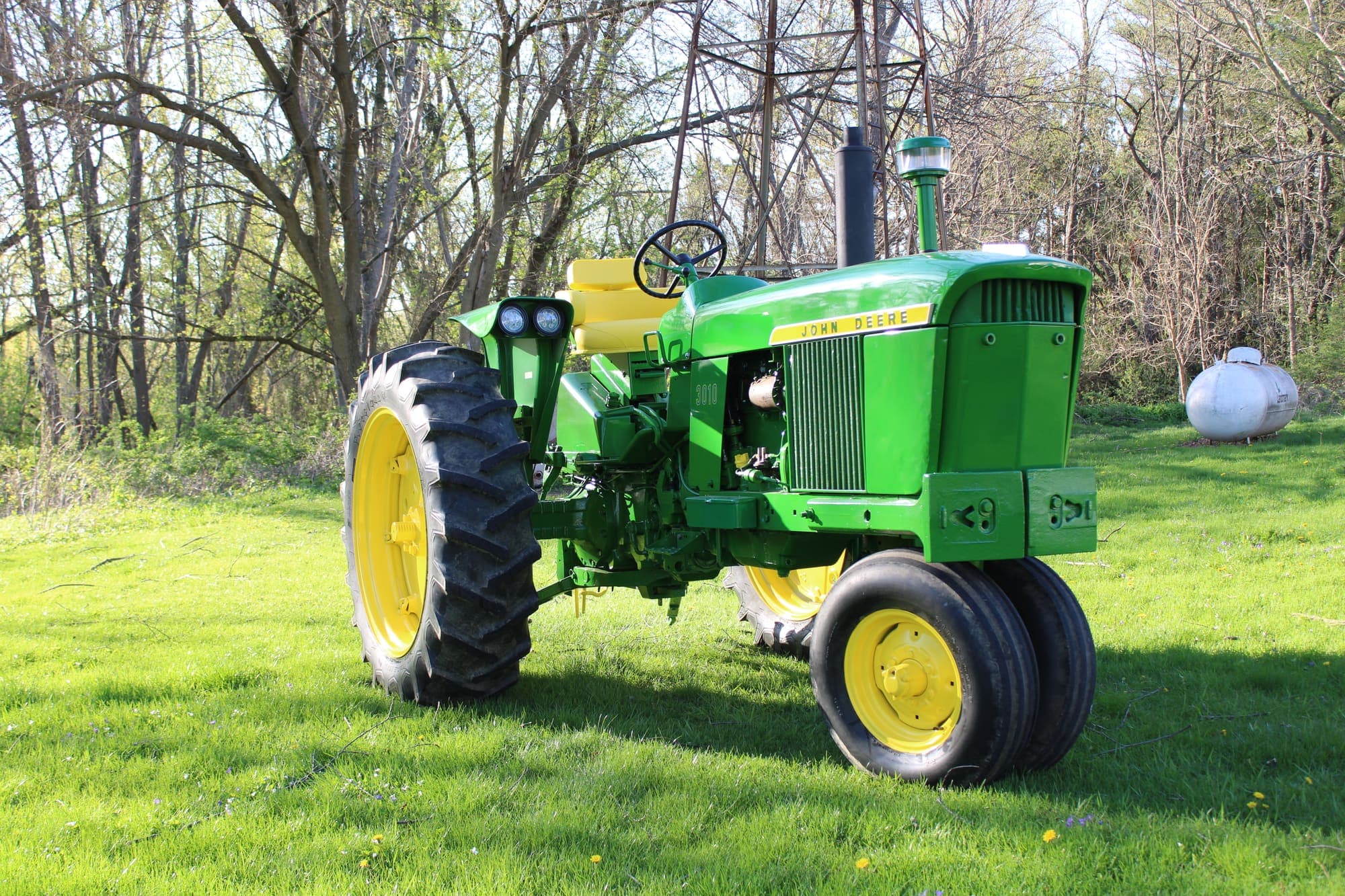 Dan's restored John Deere 3010 parked on the grass in fresh paint